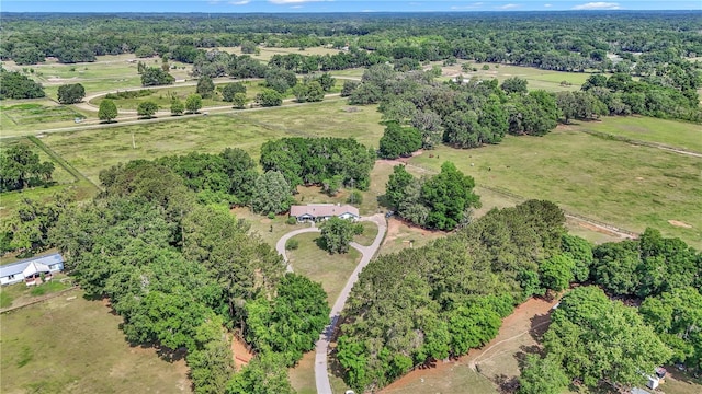 aerial overview of property's location with a heavily wooded area
