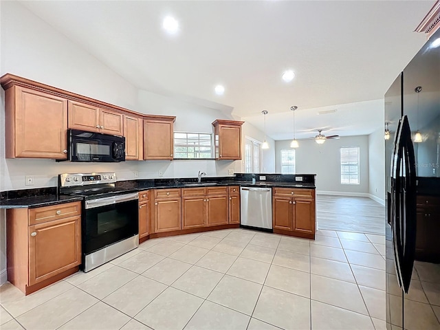 kitchen featuring a peninsula, a sink, lofted ceiling, black appliances, and light tile patterned flooring