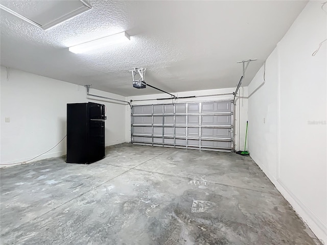 garage with freestanding refrigerator and a garage door opener
