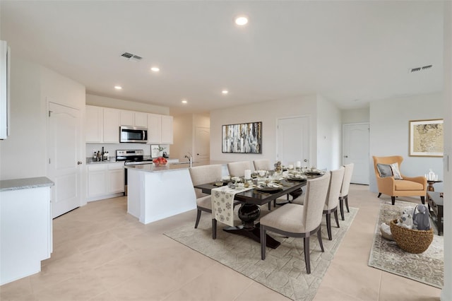 dining area featuring light tile patterned floors, visible vents, and recessed lighting