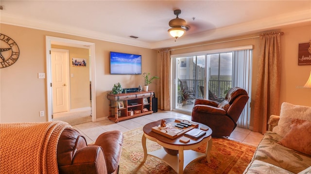 living room featuring ornamental molding, light tile patterned flooring, a ceiling fan, and visible vents