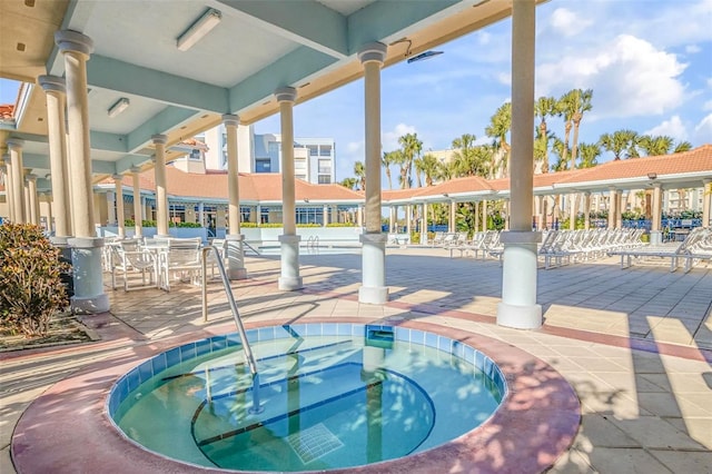 view of pool with a hot tub