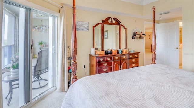 bedroom featuring multiple windows, visible vents, and access to exterior