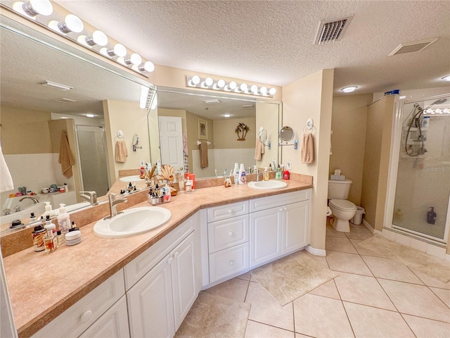 full bathroom with double vanity, visible vents, a shower stall, and a sink