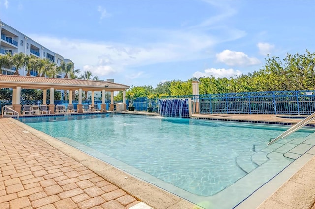 community pool featuring a patio area and fence