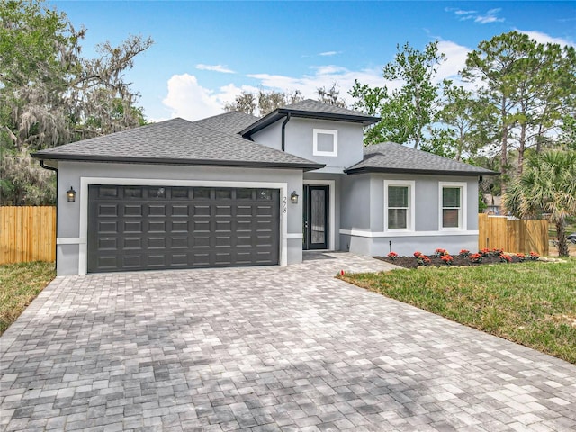 278 Acorn Dr, Longwood, FL 32750 - prairie-style home with fence, a garage, stucco siding, a front yard, and decorative driveway