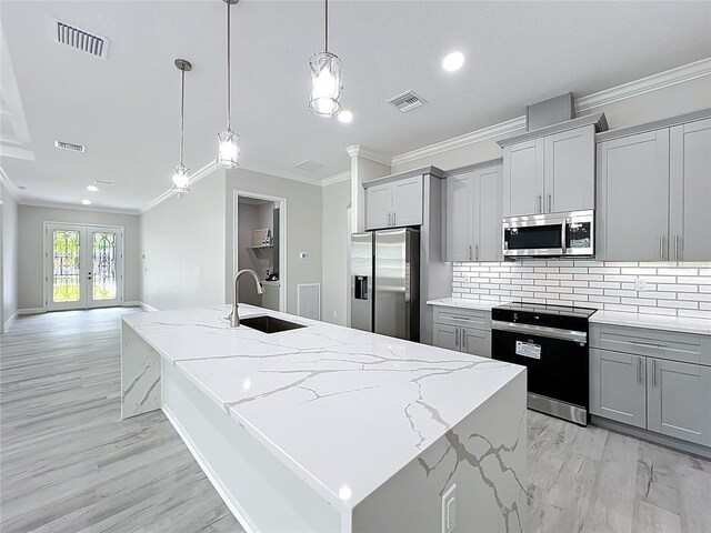 278 Acorn Dr, Longwood, FL 32750 - kitchen featuring crown molding, gray cabinetry, visible vents, and appliances with stainless steel finishes