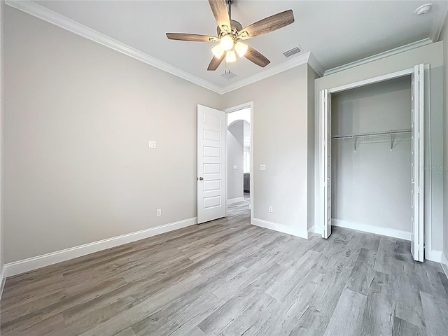 278 Acorn Dr, Longwood, FL 32750 - unfurnished bedroom with ornamental molding, visible vents, arched walkways, baseboards, and light wood-style floors