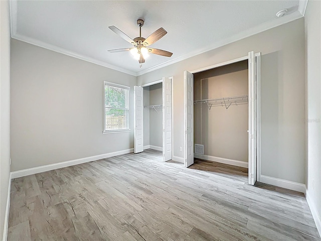 278 Acorn Dr, Longwood, FL 32750 - unfurnished bedroom featuring ornamental molding, wood finished floors, baseboards, and multiple closets
