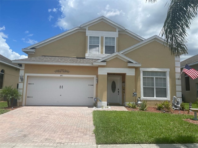 447 Cadiz Loop, Davenport, FL 33837 - view of front of home featuring stucco siding, a front lawn, and decorative driveway