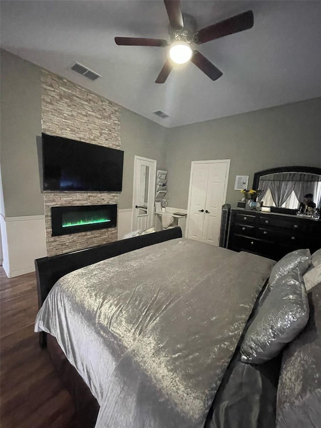 447 Cadiz Loop, Davenport, FL 33837 - bedroom with a ceiling fan, visible vents, wood finished floors, and a fireplace