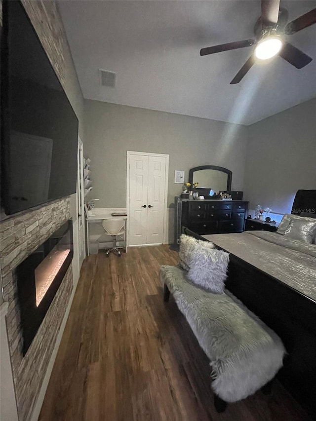 447 Cadiz Loop, Davenport, FL 33837 - bedroom with a ceiling fan, a stone fireplace, and wood finished floors
