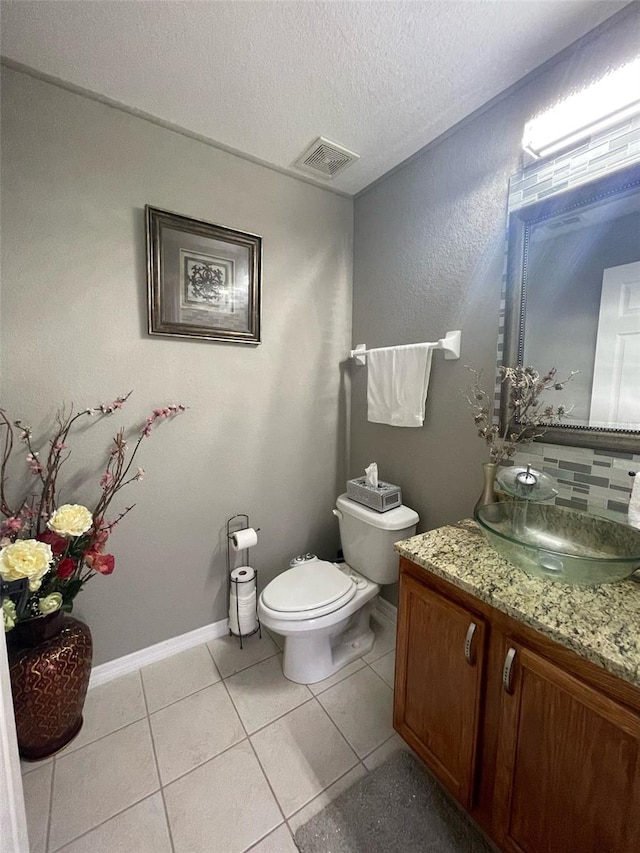 447 Cadiz Loop, Davenport, FL 33837 - bathroom featuring toilet, a textured ceiling, visible vents, tile patterned flooring, and vanity