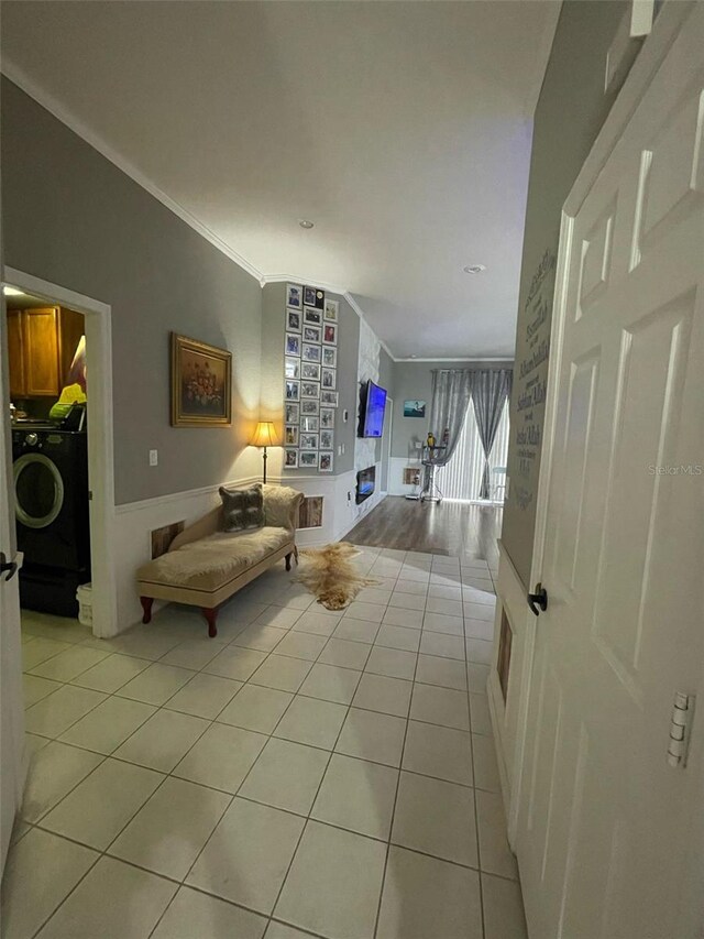 447 Cadiz Loop, Davenport, FL 33837 - living room with washer / dryer, crown molding, and light tile patterned flooring
