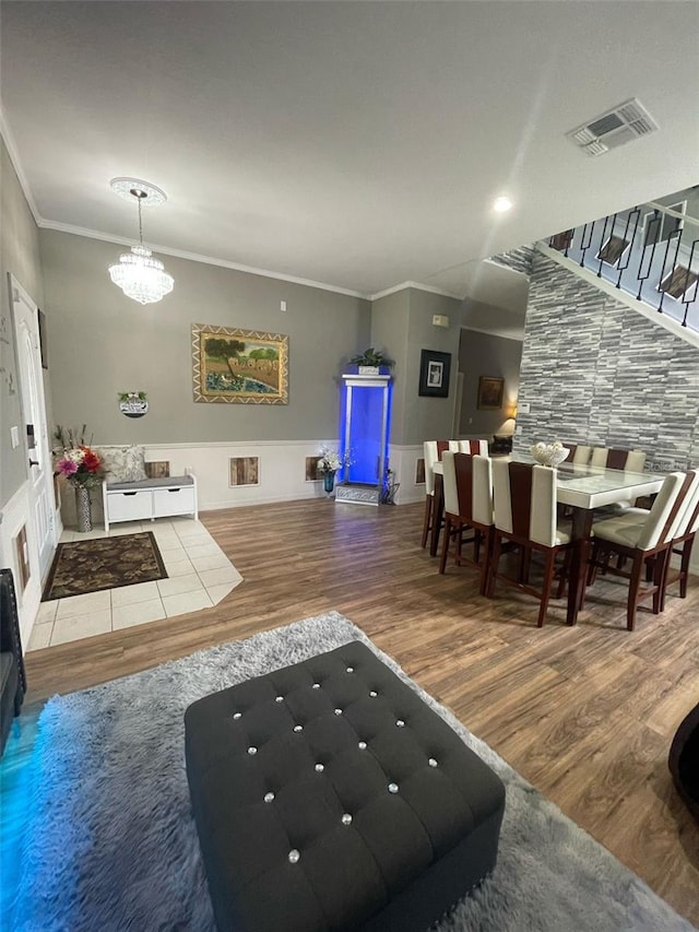 447 Cadiz Loop, Davenport, FL 33837 - interior space featuring an inviting chandelier, ornamental molding, visible vents, and wood finished floors