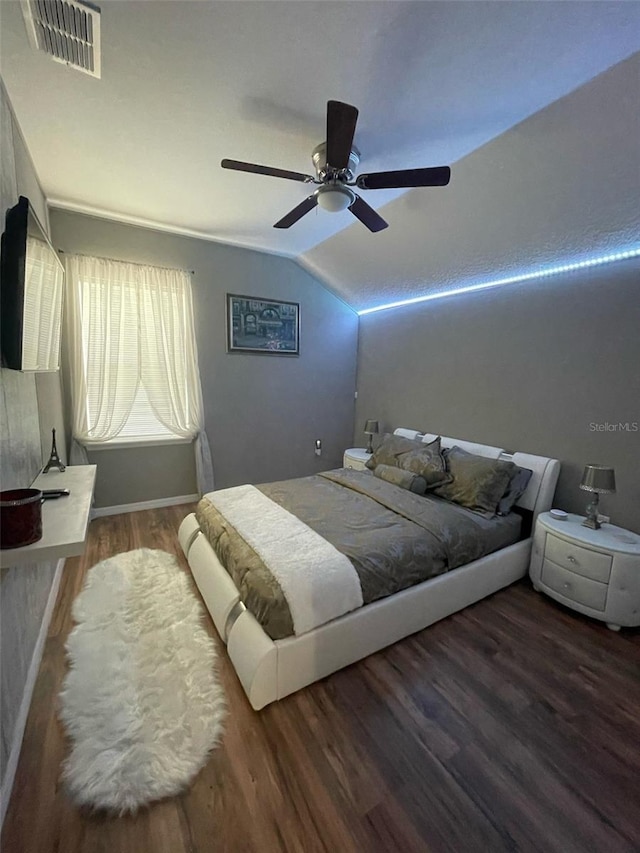 447 Cadiz Loop, Davenport, FL 33837 - bedroom featuring wood finished floors, visible vents, vaulted ceiling, ceiling fan, and baseboards