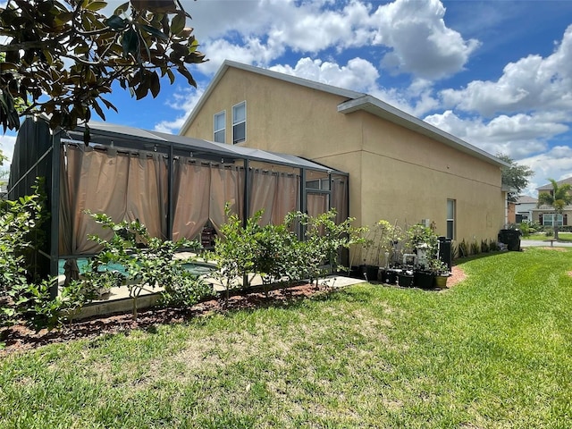 447 Cadiz Loop, Davenport, FL 33837 - view of property exterior featuring stucco siding and a lawn