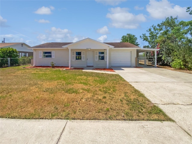 38832 Henry Dr, Zephyrhills, FL 33542 - ranch-style house featuring a front lawn, stucco siding, fence, and a garage