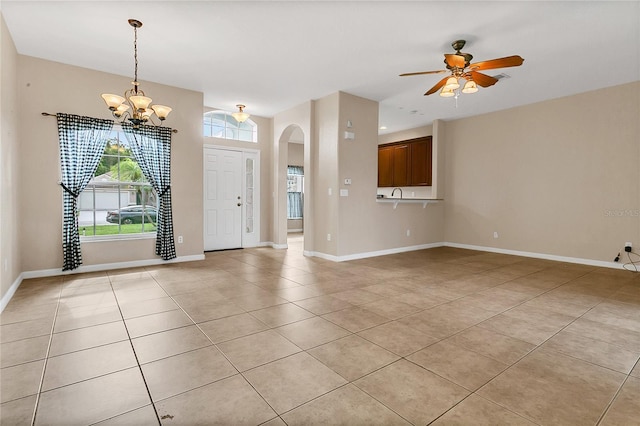 2975 White Cedar Cir, Kissimmee, FL 34741 - foyer entrance with light tile patterned floors, a chandelier, arched walkways, and ceiling fan