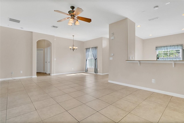 2975 White Cedar Cir, Kissimmee, FL 34741 - unfurnished room featuring arched walkways, a ceiling fan, a chandelier, light tile patterned flooring, and a smoke detector