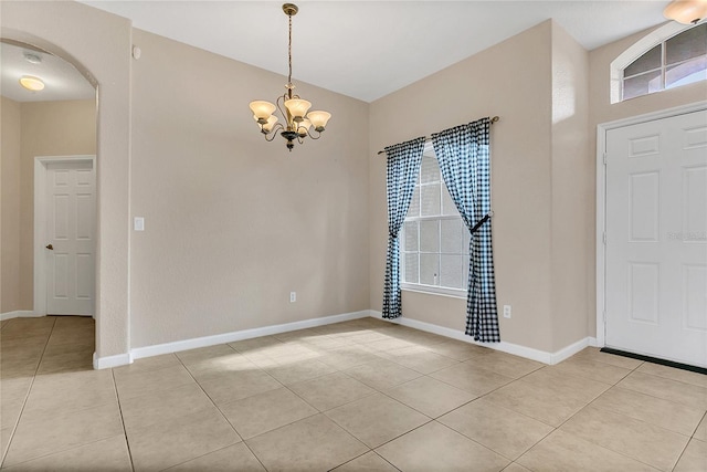 2975 White Cedar Cir, Kissimmee, FL 34741 - entrance foyer with light tile patterned floors, arched walkways, a chandelier, and healthy amount of natural light