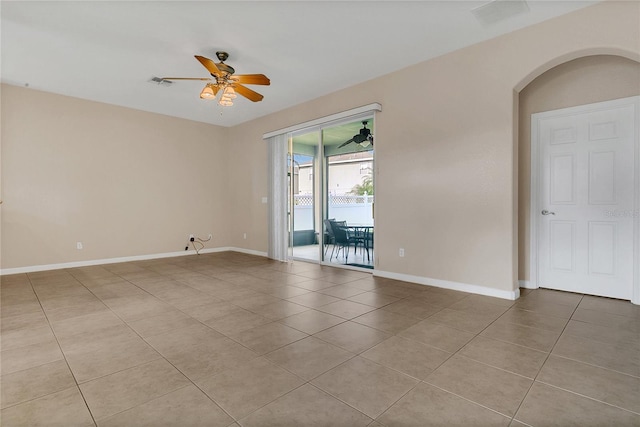 2975 White Cedar Cir, Kissimmee, FL 34741 - spare room featuring light tile patterned floors, a ceiling fan, and arched walkways