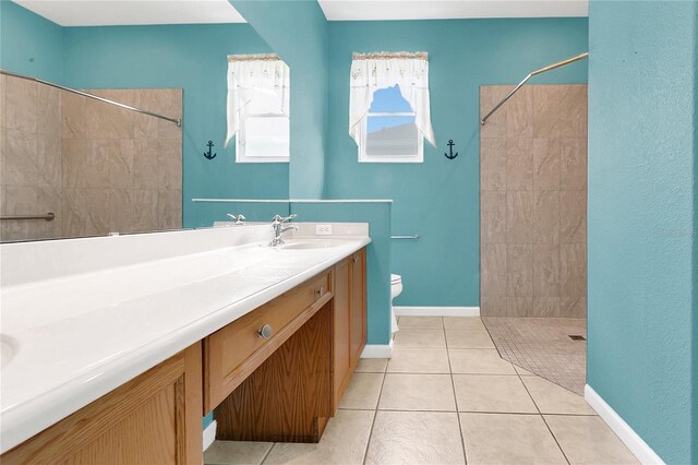 2975 White Cedar Cir, Kissimmee, FL 34741 - bathroom with a tile shower, vanity, and tile patterned flooring