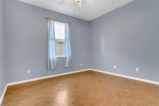 2975 White Cedar Cir, Kissimmee, FL 34741 - spare room featuring wood finished floors and a ceiling fan