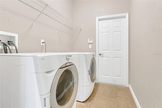 2975 White Cedar Cir, Kissimmee, FL 34741 - laundry area with independent washer and dryer and light tile patterned floors