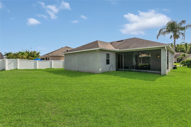 2975 White Cedar Cir, Kissimmee, FL 34741 - rear view of house featuring a sunroom, stucco siding, and roof with shingles