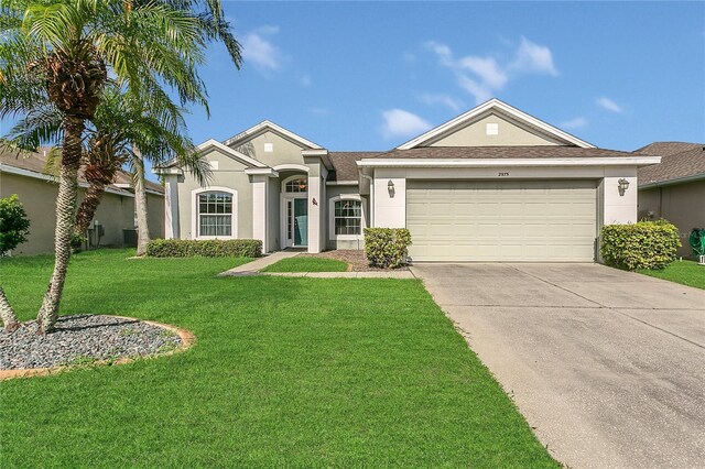 2975 White Cedar Cir, Kissimmee, FL 34741 - single story home with a garage, stucco siding, concrete driveway, and a front yard