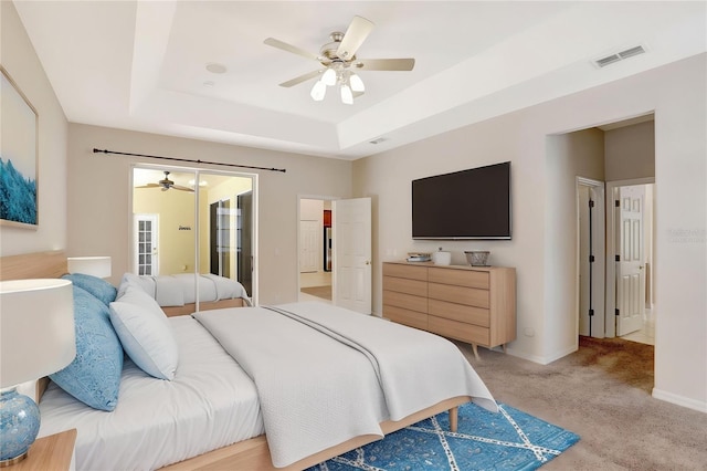 626 Green Rock Ct, Apopka, FL 32712 - bedroom with a tray ceiling, light colored carpet, and a ceiling fan