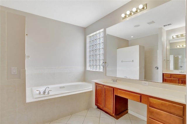 626 Green Rock Ct, Apopka, FL 32712 - bathroom featuring a garden tub, vanity, and tile patterned floors