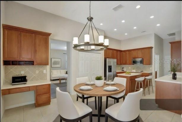 626 Green Rock Ct, Apopka, FL 32712 - dining area with light tile patterned floors, a chandelier, and recessed lighting