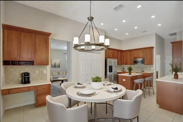 626 Green Rock Ct, Apopka, FL 32712 - dining room with light tile patterned flooring, a chandelier, and recessed lighting