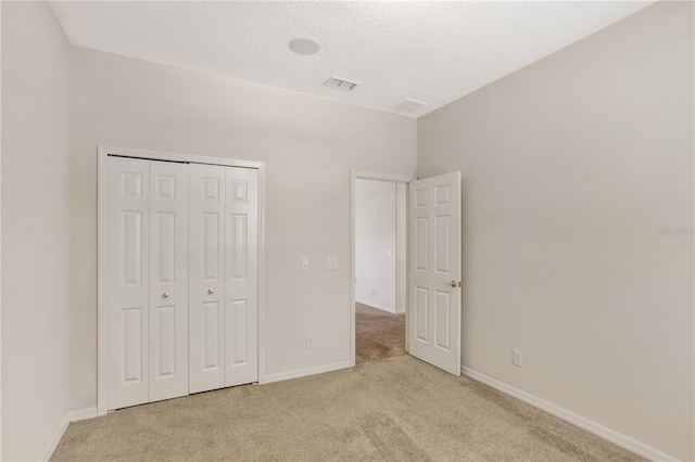 626 Green Rock Ct, Apopka, FL 32712 - unfurnished bedroom with light carpet, a closet, and a textured ceiling