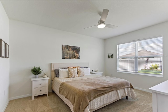 1975 Cacutta Way, Kissimmee, FL 34744 - bedroom featuring light carpet, baseboards, and a ceiling fan