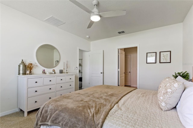 1975 Cacutta Way, Kissimmee, FL 34744 - bedroom with light colored carpet, baseboards, and a ceiling fan