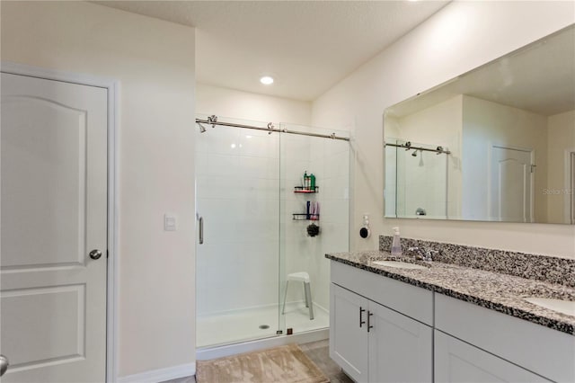 1975 Cacutta Way, Kissimmee, FL 34744 - bathroom featuring a shower stall, double vanity, and recessed lighting