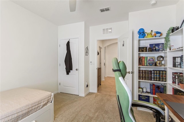 1975 Cacutta Way, Kissimmee, FL 34744 - bedroom with light carpet, a desk, light tile patterned flooring, a ceiling fan, and baseboards
