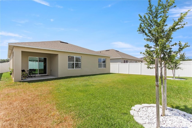 1975 Cacutta Way, Kissimmee, FL 34744 - rear view of house featuring stucco siding and a patio