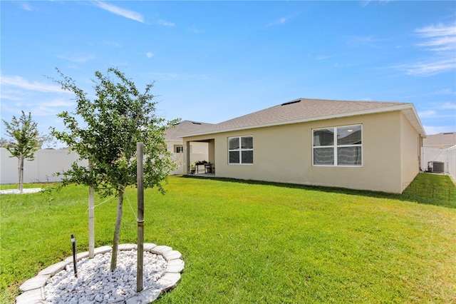 1975 Cacutta Way, Kissimmee, FL 34744 - rear view of property with stucco siding and central air condition unit