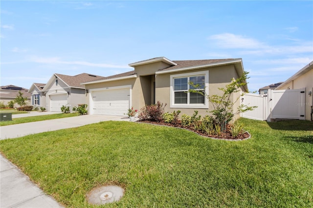 1975 Cacutta Way, Kissimmee, FL 34744 - ranch-style house featuring a garage, concrete driveway, stucco siding, and a gate