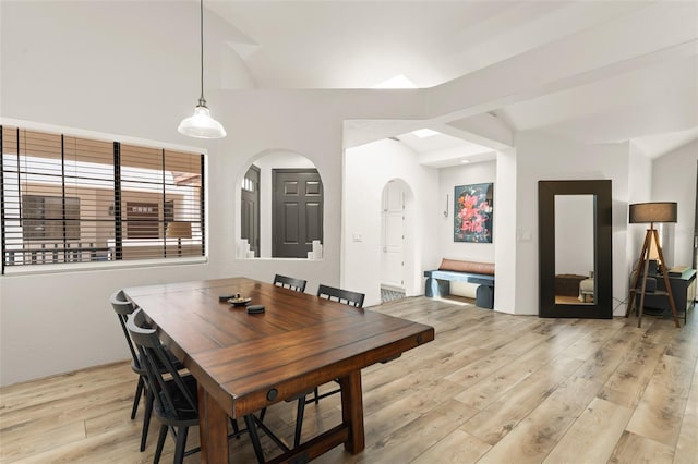 546 Via Fontana Dr Unit 203, Altamonte Springs, FL 32714 - dining room with light wood-style flooring, lofted ceiling, and arched walkways