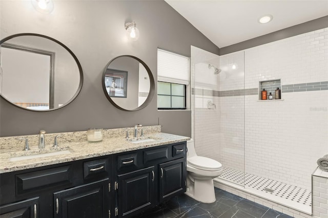 546 Via Fontana Dr Unit 203, Altamonte Springs, FL 32714 - bathroom featuring toilet, vaulted ceiling, a tile shower, and a sink