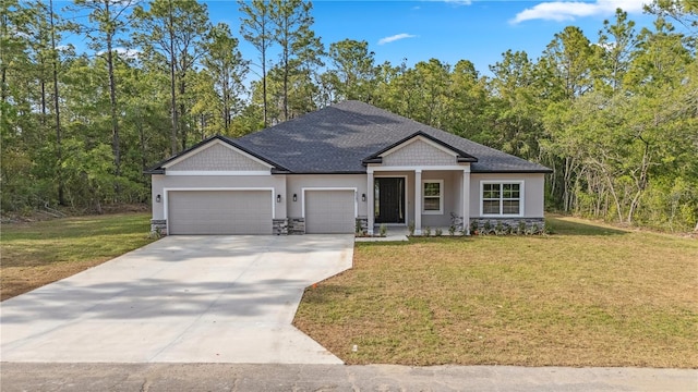 view of front of home with an attached garage, driveway, a front yard, stone siding, and stucco siding
