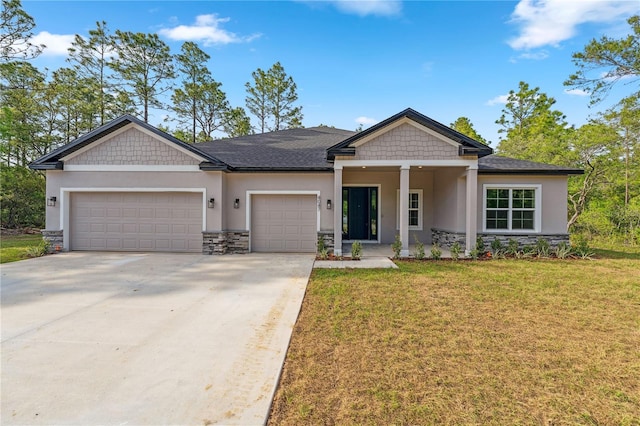 view of front of home featuring stone siding, stucco siding, a garage, and driveway