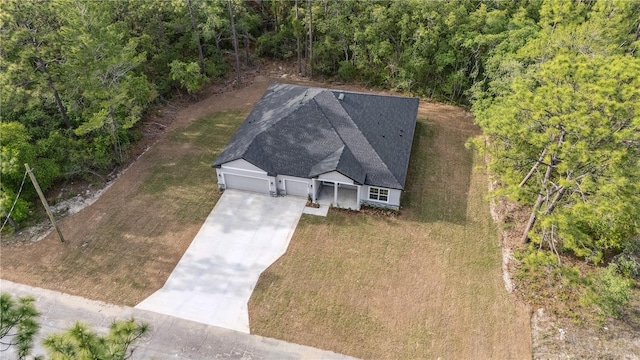 view from above of property featuring a heavily wooded area
