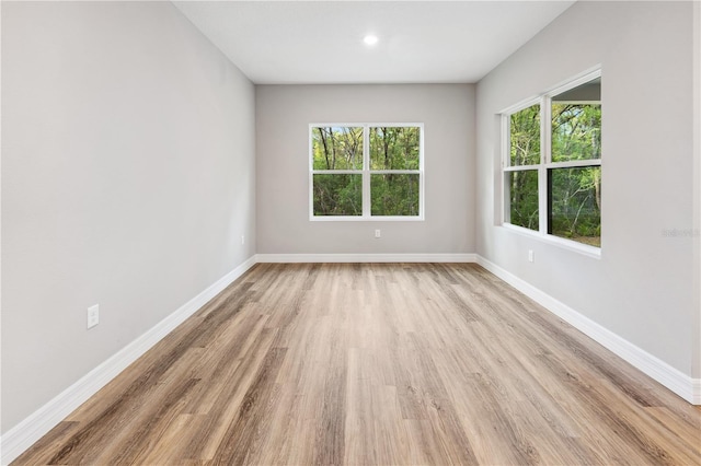 empty room featuring light wood-style floors and baseboards