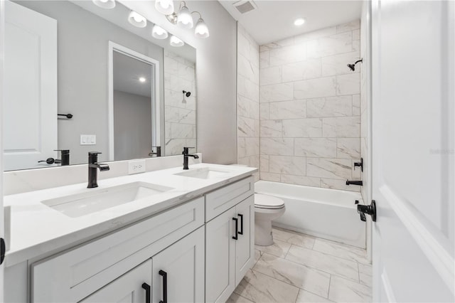 full bathroom featuring marble finish floors, toilet, double vanity, tiled shower / bath, and recessed lighting